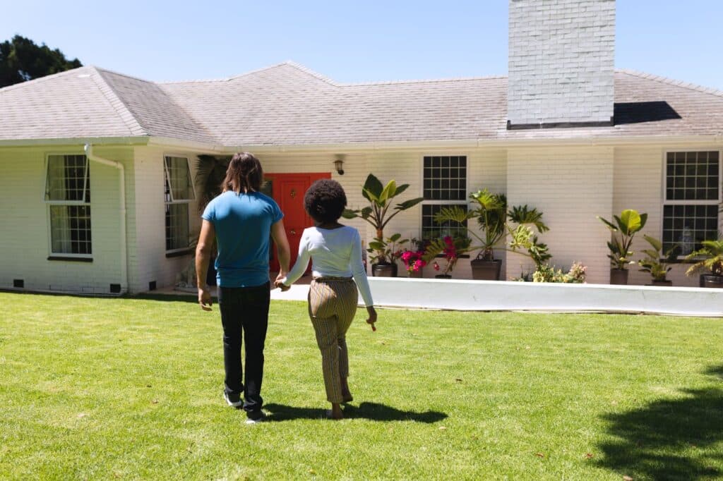 A couple walks toward their home in the daylight, presumably after meeting with the best property tax protest company in Texas